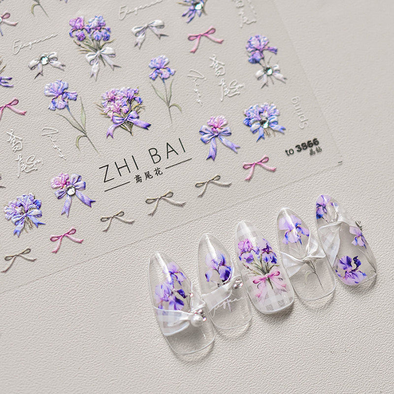 Close-up of delicate floral nail art decals with blue flowers